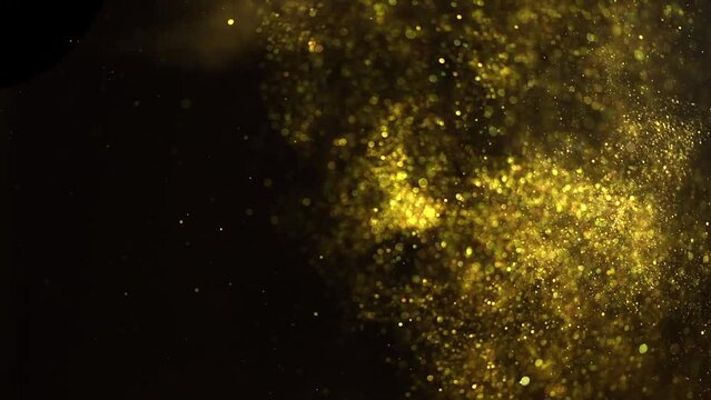 Floating gold sparks, glitter golden sparkles explosion on black background. Flying Gold particles, Dust. Christmas golden light shine particles flying bokeh. Backdrop. Holiday concept. Slow motion. 