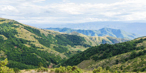 Summer nature mountains landscape. Scenery of green hills and fields. Beautiful blue sky with clouds. Panoramic view of Mountain Kopaonik, Serbia, Europe.