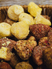 hand made baked stuffed rolls and pieces of cheese. Delicious pastries on wooden cutting board and parchment paper at the street food fair. Soft focus blurred and noise effect