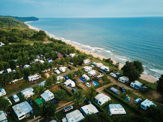 Aerial view of campsite with trailers near Baltic sea beach in Wladyslawowo, Poland. Tourists have rest during summer vacation season