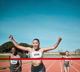 Happy woman, running and winning by finish line in competition, race or marathon on outdoor stadium...