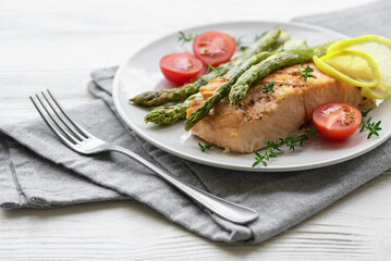 Baked Delicious salmon, green asparagus on  plate