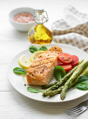 Baked Delicious salmon, green asparagus on  plate