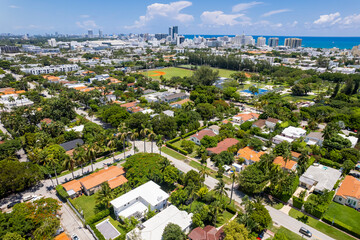Miami Beach, Florida, USA - Aerial view of houses and low-rise apartments with South Beach skyline in the background.