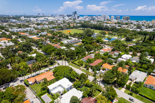 Miami Beach, Florida, USA - Aerial view of houses and low-rise apartments with South Beach skyline in the background.