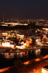 Top view of the night city, lights of lamps and cars in the dark