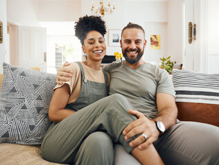 Obraz premium Home, love and couple on a couch, portrait or marriage with happiness, bonding and relax in lounge. Interracial, man or woman on a sofa, trust and romantic with relationship, commitment and dating