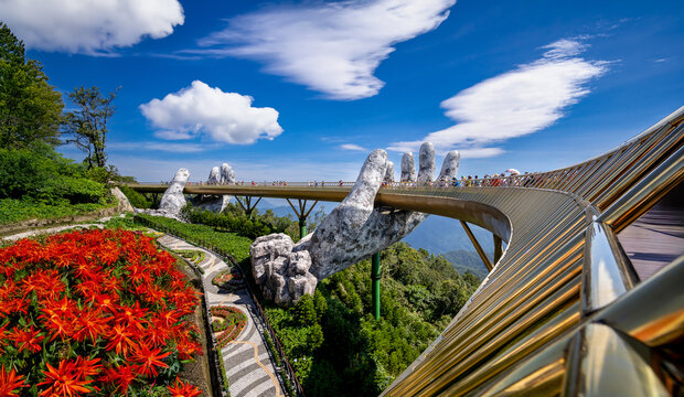 Bana Hills, Danang Vietnam - AUGUST , 2023:Golden bridge on the top of the Ba Na Hills, Danang city, the famous tourist attraction in central vietnam. a pair of giant hands