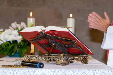 Eucharist ceremony during mass. Catholic ritual. Priest in a white cassock celebrating mass.