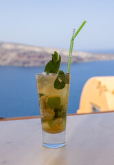 Mojito cocktail in a glass with a straw