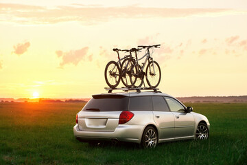 Bike transportation. Bicycles on the roof of a car against a beautiful sky. Transportation and...