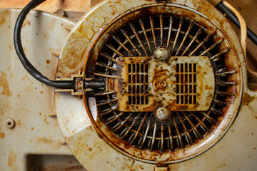 Obraz premium Dirty with burned grease cooker hood filter fan motor, soft focus close up