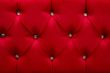 Red fabric with buttons, diamond shaped pattern,