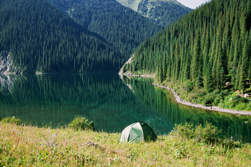 Tourist tent on the shore of a mountain lake