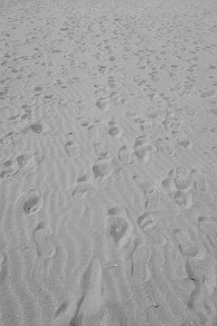 Black and white abstract background beach sand with foot print marks