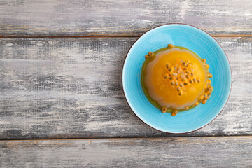 Mango and passion fruit jelly  on gray wooden, top view, copy space.