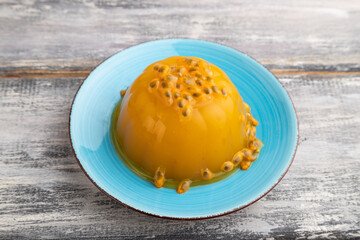 Mango and passion fruit jelly  on gray wooden, side view.