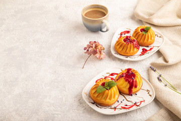 Semolina cheesecake with strawberry jam on gray concrete, side view, copy space.
