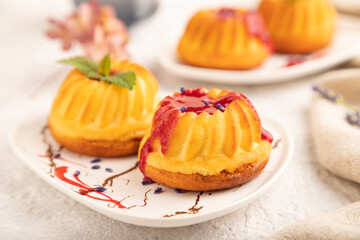 Semolina cheesecake with strawberry jam on gray concrete, side view, selective focus.