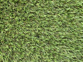 Green artificial grass background. Artificial turf stadium texture.