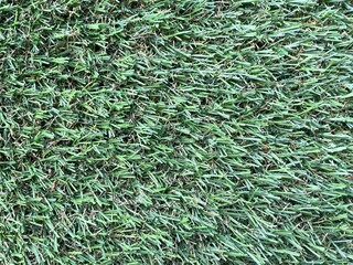 Green artificial grass background. Artificial turf stadium texture.