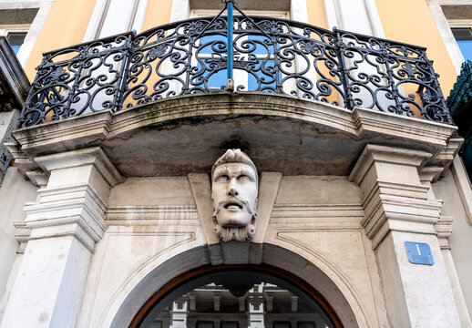 Human head-shaped sculpture called "Panduro" above the entrance of a palace in Capo di Piazza street, Trieste city center, Italy