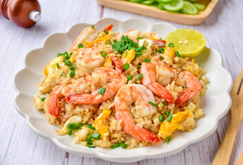 Fried rice with shrimps on a white plate, cloee up food