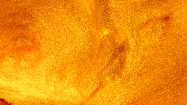 Liquid gold moving, golden abstract background. Flowing Golden abstract backdrop. Beautiful metallic yellow texture, swirls. Liquid Gold metallic paint close-up. Art Wallpaper waves.
