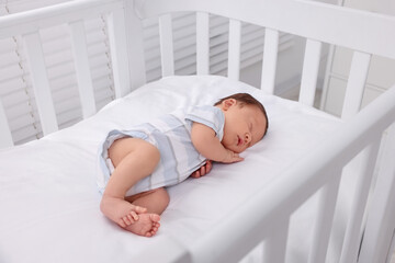 Obraz na płótnie Canvas Cute newborn baby sleeping in crib. Bedtime