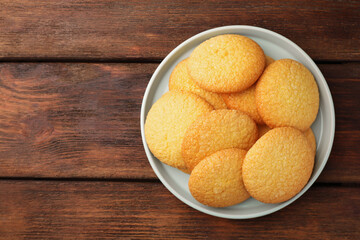 Delicious Danish butter cookies on wooden table, top view. Space for text