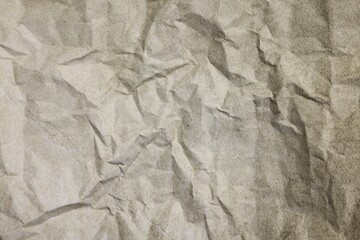 Texture of crumpled parchment paper as background, top view