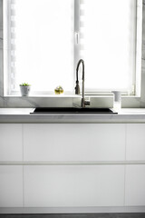 White scandinavian kitchen interior. A modern comfortable kitchen in a minimalist style. Interior design concept