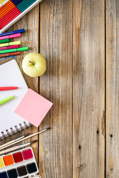 Flat lay school stationery on a wooden background, back to school concept, copy space.