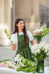 Florist at work. Woman making beautiful bouquet of different flowers. Workplace. Small business.