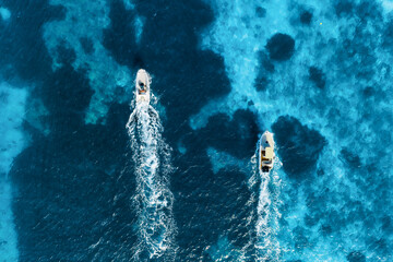 Vacation and leisure. Aerial view on fast boats on blue Mediterranean sea at sunny day. Fast ships on the sea surface. Seascape from the drone. Seascape from air. Seascape with motorboats.