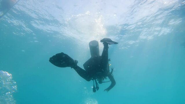 silhouette scuba diver sun beam shine rays underwater  diver relaxing in blue ocean scenery 4k slow motion footage 