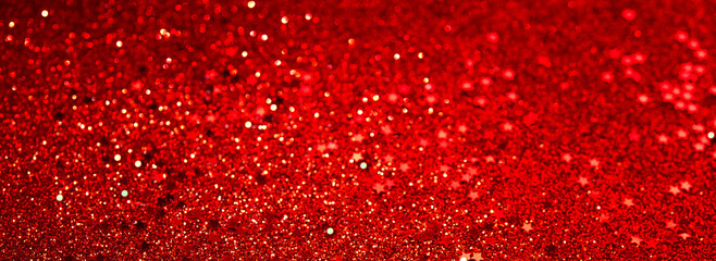 Red glitter confetti abstract red background, luxury Christmas backdrop with red stars. Brilliant colored sequins. Holiday greeting card.	
