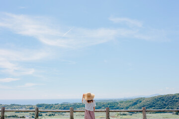 Japanese summer girl with straw hat at countryside.