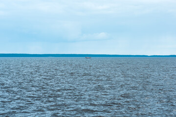 Obraz premium waterscape of Lake Onega, the silhouette of longship is visible in the distance