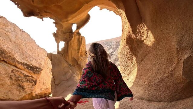 First view of one happy beautiful girl holding hand of her boyfriend walking and discovering new places enjoying and having fun on vacations, freedom concept traveling