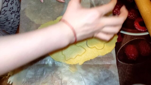 Young woman makes figured christmas cookies