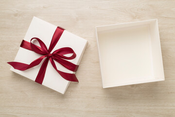 Open gift box on wooden background, top view. Mock up for design