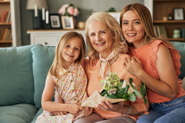 Happy three generation family celebrating grandmothers birthday portrait