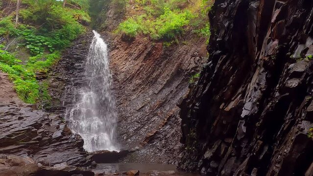 Fantastic summer view from the deep canyon of Zhenetsʹkyy Huk waterfall. Amazing morning scene of Carpathian mountains, Ukraine, Europe. 4K video (Ultra High Definition)..