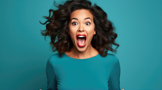 Young Woman Wearing Casual Clothes Shocked With Surprise And Amazed Expression On Blue Background