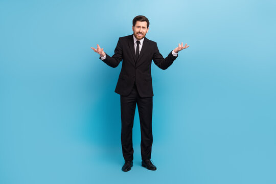 Full body photo of confused businessman shrug shoulders wtf scandal bad mood dissatisfied wear costume isolated on blue color background