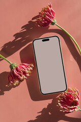 Mobile phone with mockup copy space screen, gerber flowers with aesthetic sunlight shadows on...