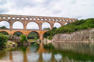 Panoramic view of ancient old Roman Aqueduct Pont du Gard ear Vers-Pon-du-Gard, Occitanie, France,...