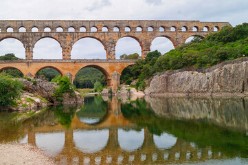 Panoramic view of ancient old Roman Aqueduct Pont du Gard ear Vers-Pon-du-Gard, Occitanie, France,...