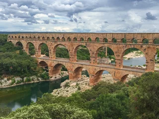 Fototapete Pont du Gard Panoramic view of ancient old Roman Aqueduct Pont du Gard ear Vers-Pon-du-Gard, Occitanie, France, Europe. Landmark over the River Gardon. Unesco world heritage site near Nimes, Languedoc-Roussillon